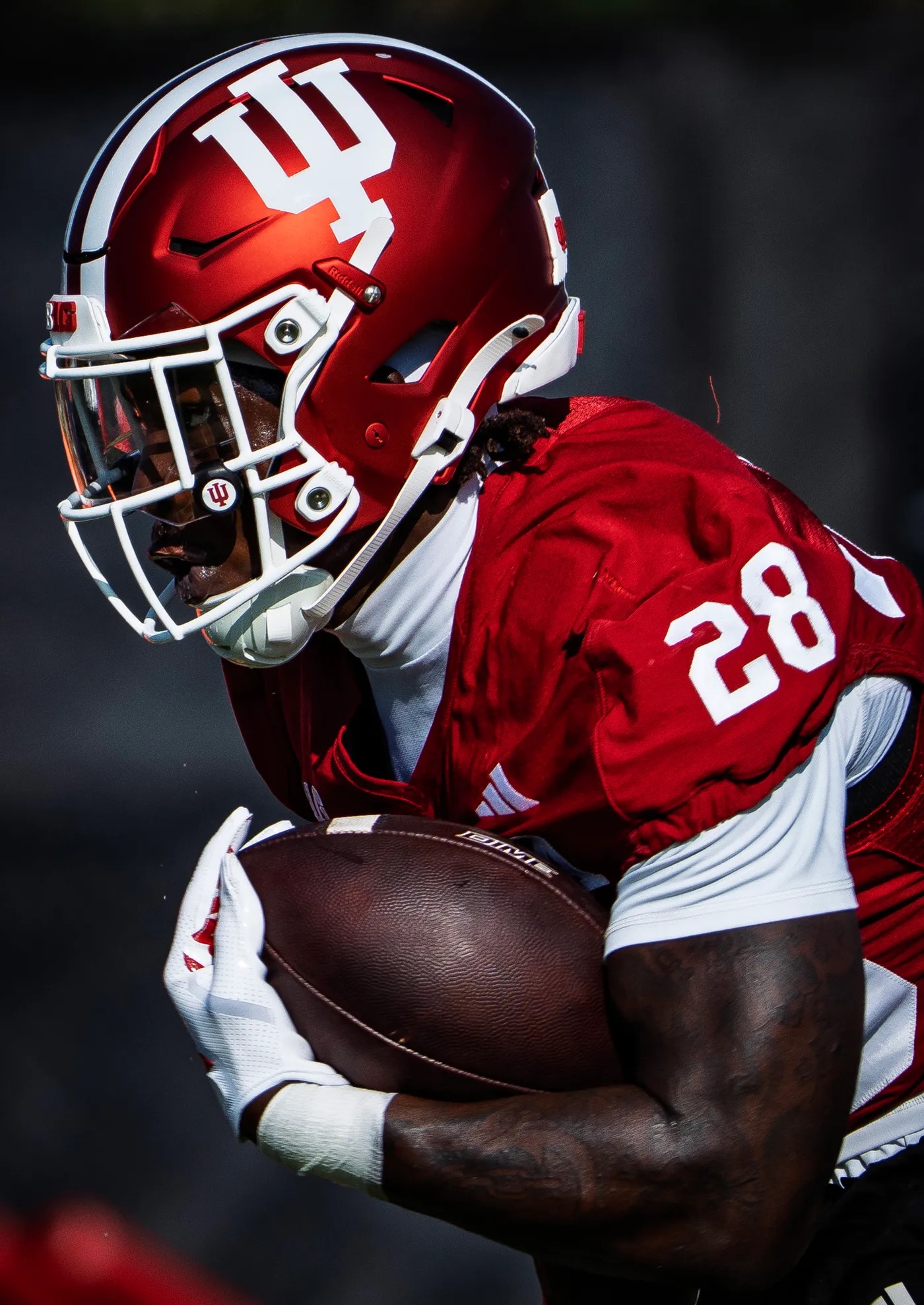 Khobie Martin carrying the football in his Indiana Hoosiers uniform